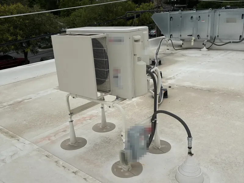 Split system condenser mounted on a commercial roof