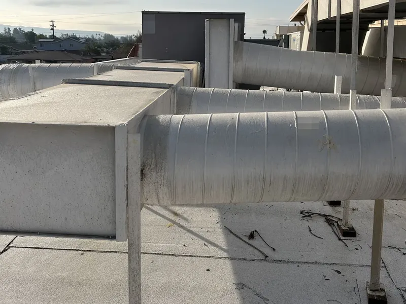 Insulated supply ductwork running across a commercial roof